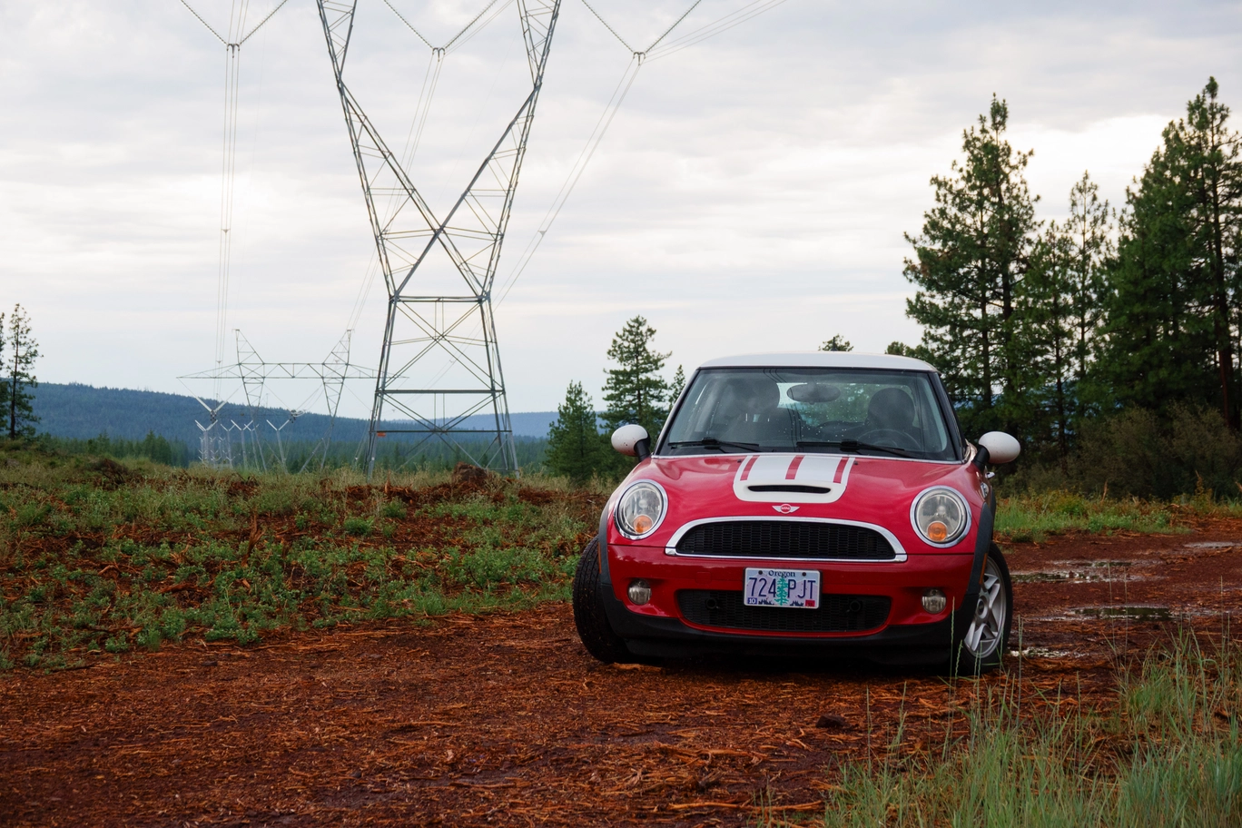 A photo of a red mini cooper and power lines