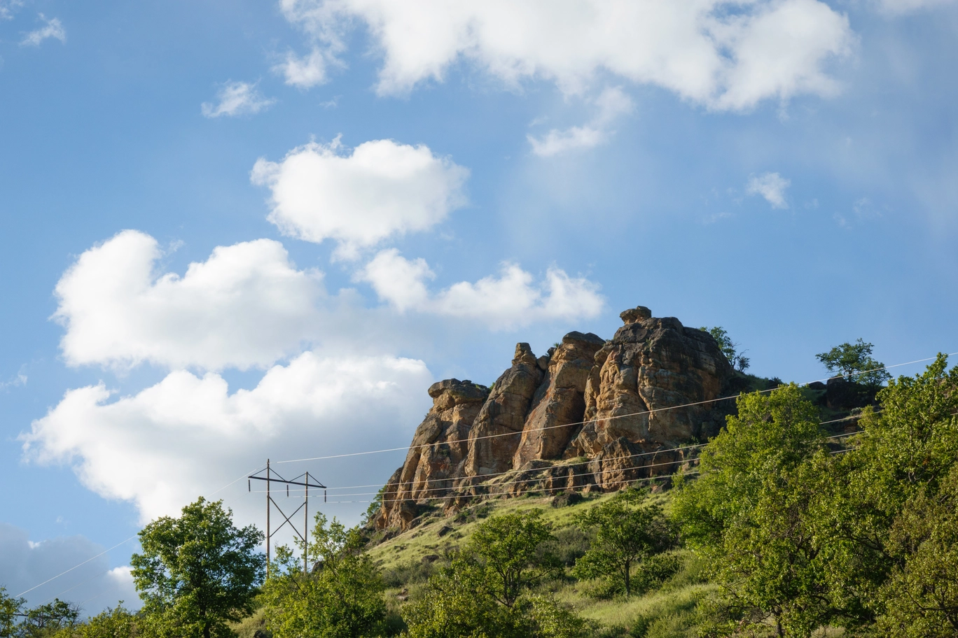 A photo of a boulder and power lines