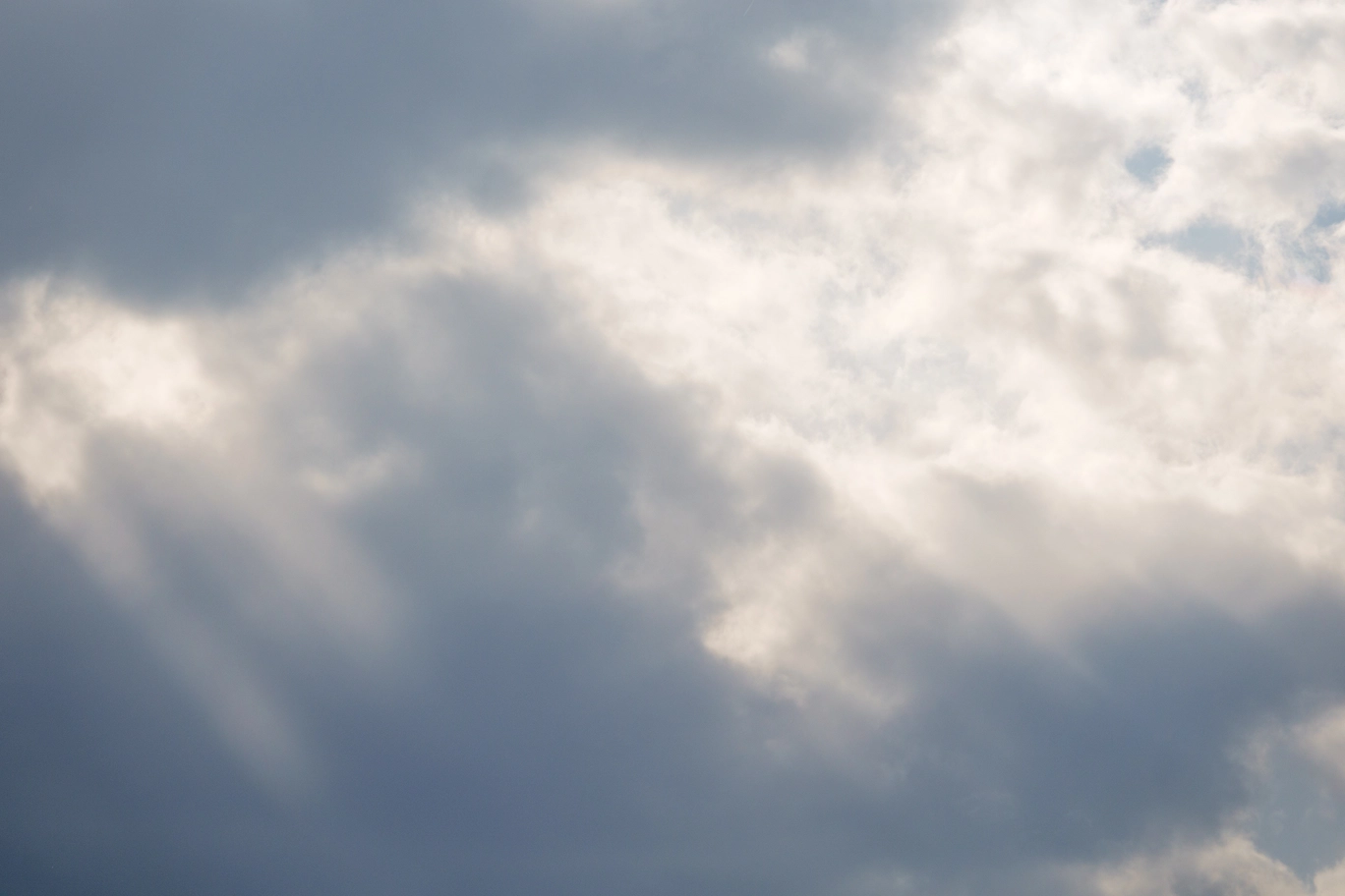 A photo of sun beams coming through clouds