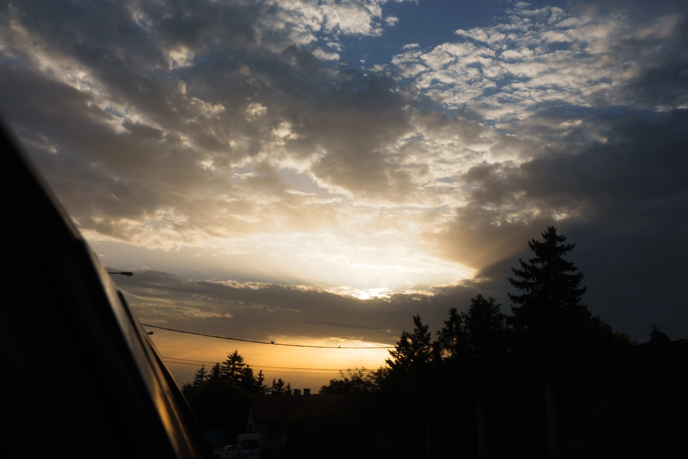 A photo of a the sun beaming through the clouds
