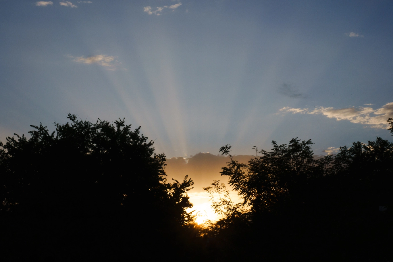 A photo of a the sun beaming through the clouds