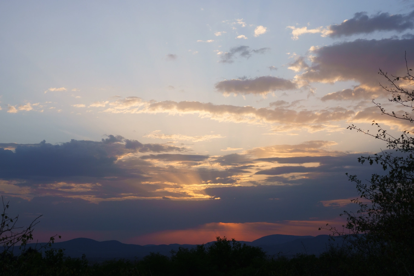 A photo of a the sun beaming through the clouds