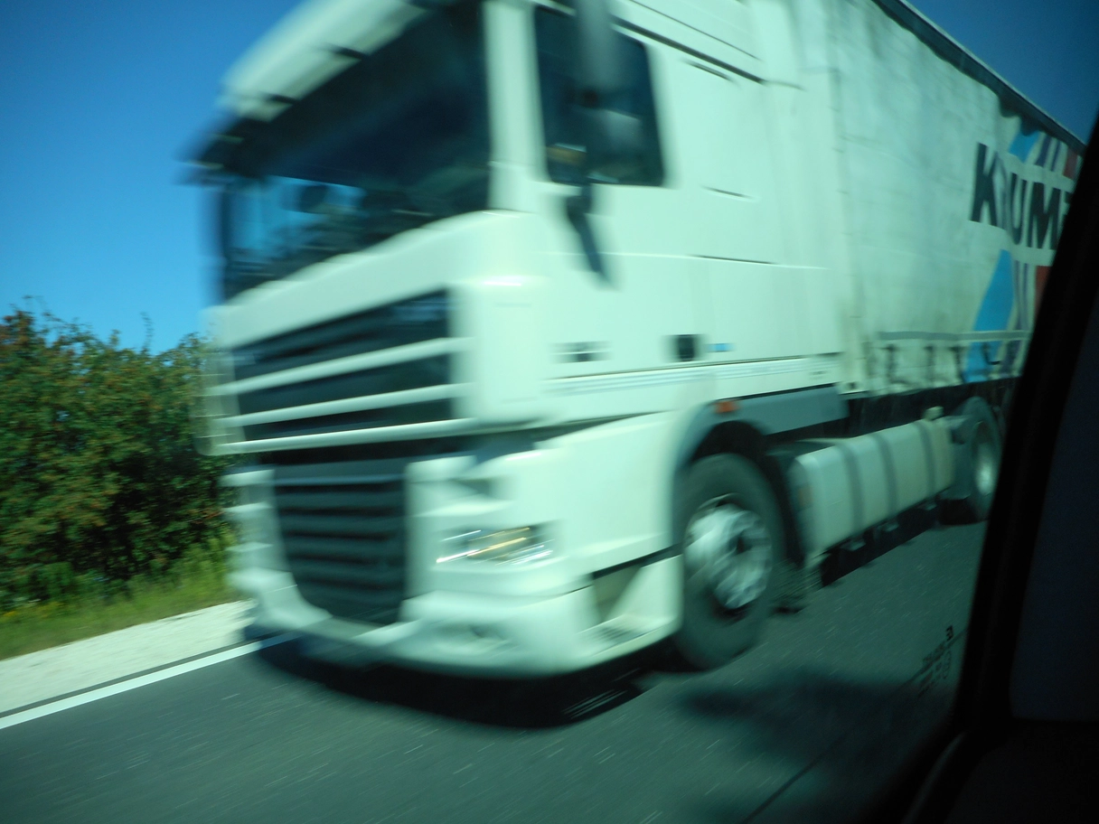 A photo of a white truck speeding by
