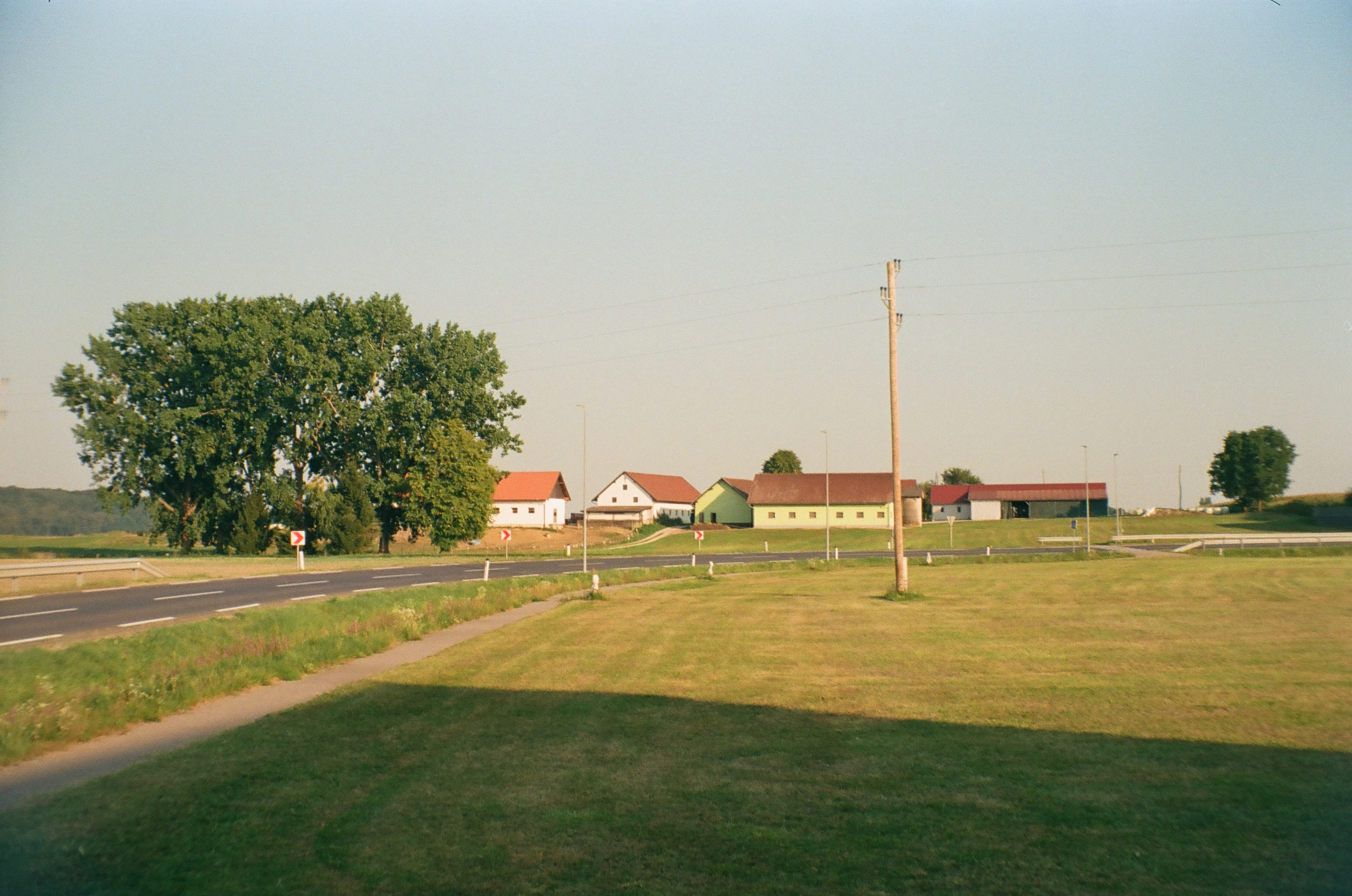 A photo of some rural houses during sunset
