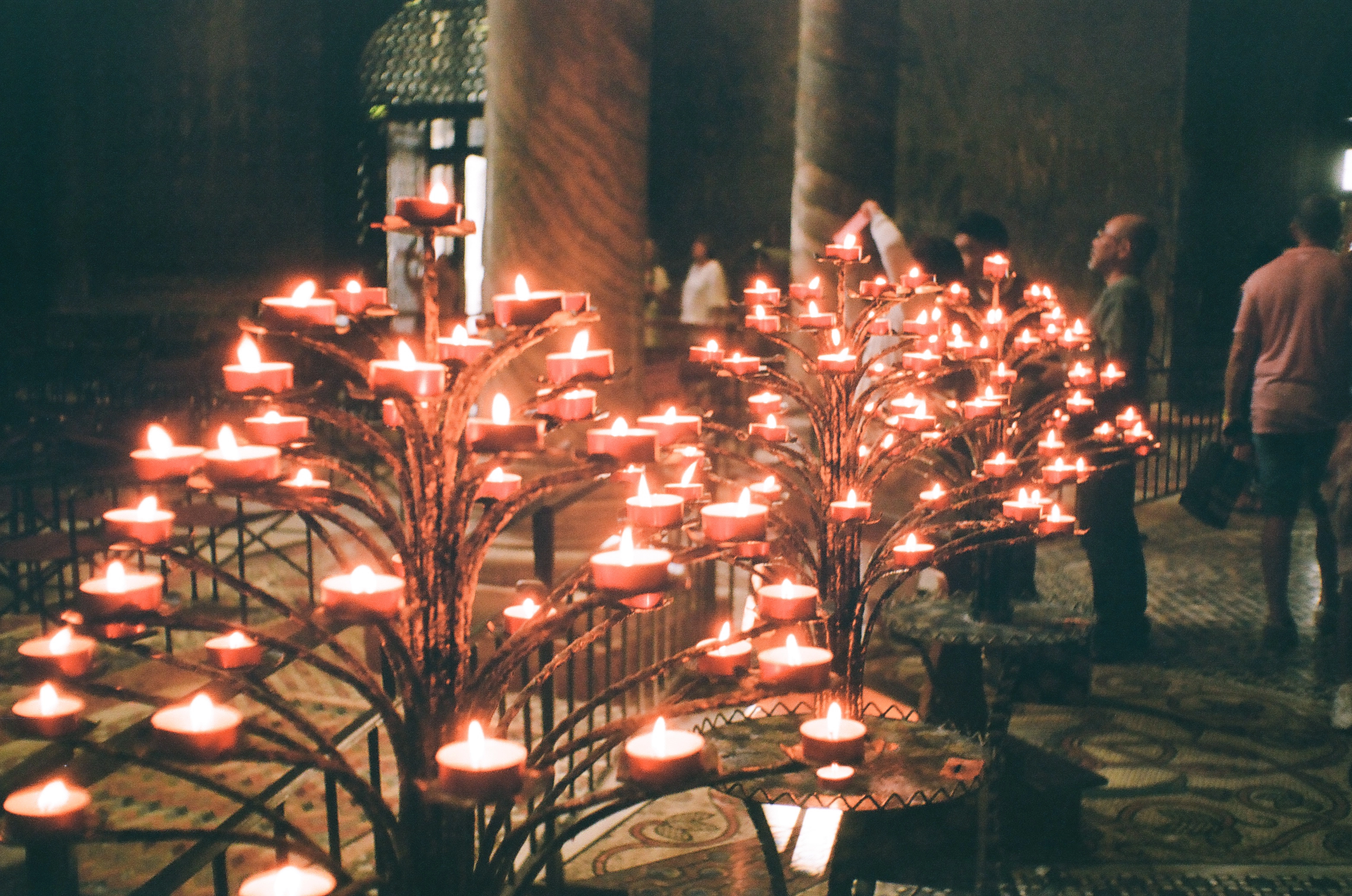 A photo of many candles in a church
