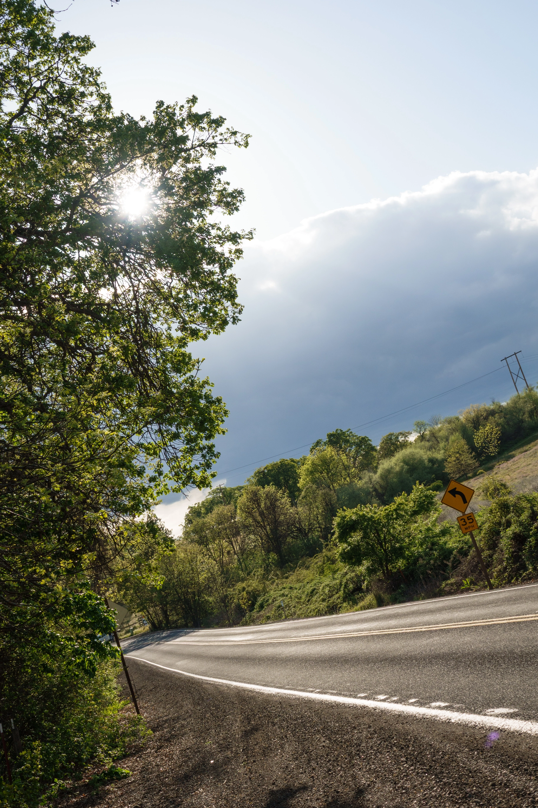 A photo of a road and the sun