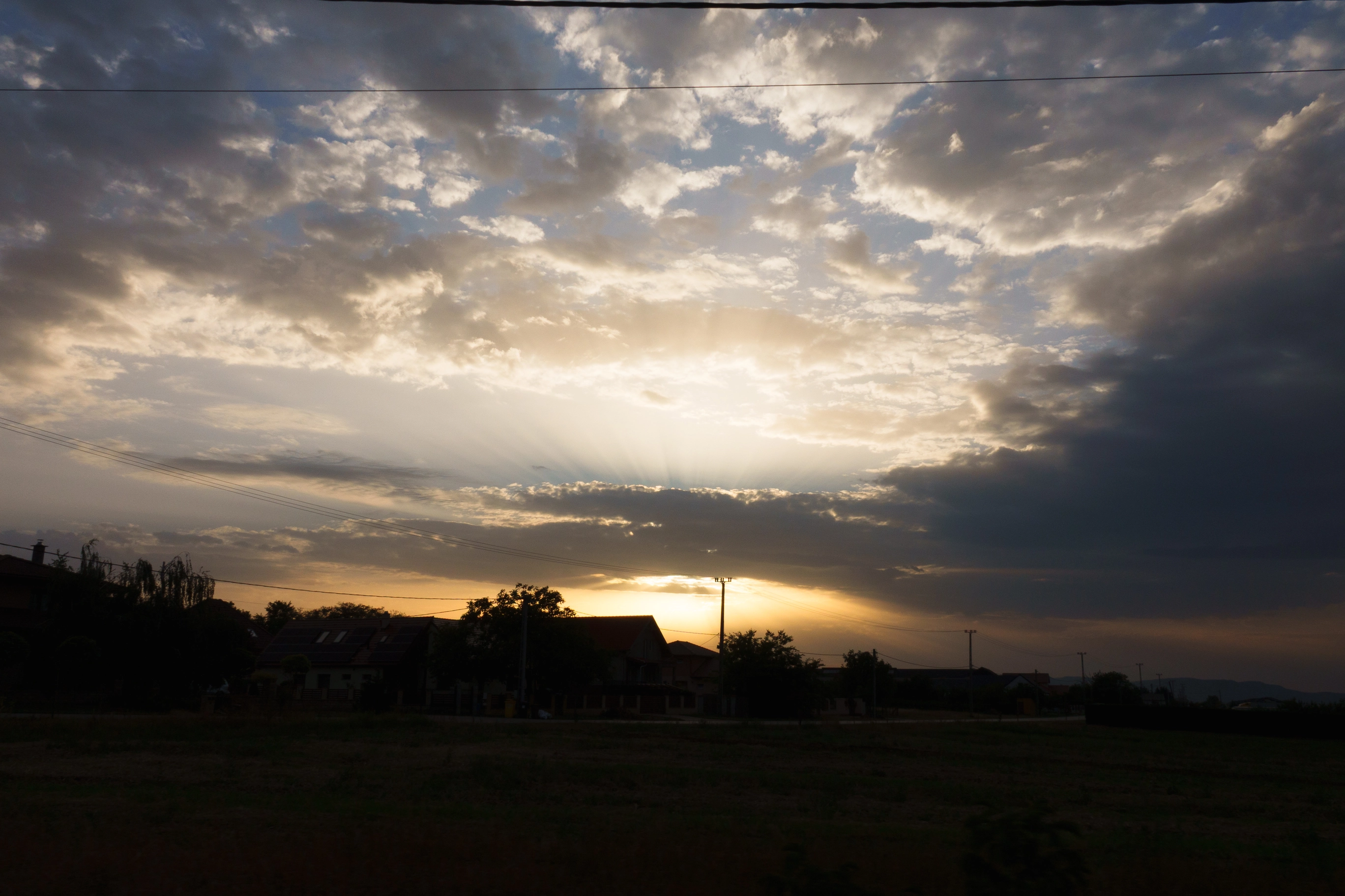 A photo of a the sun beaming through the clouds