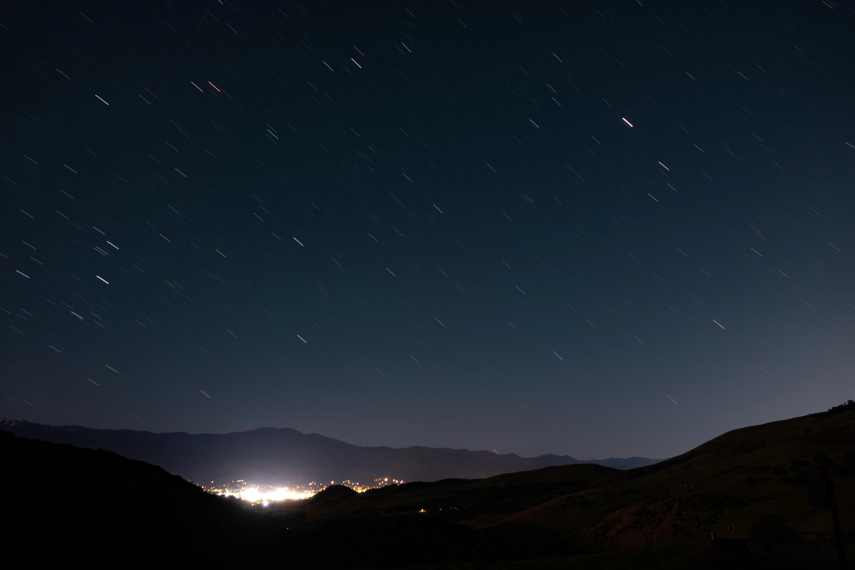 A photo of Ashland from afar with stars streaking across the sky