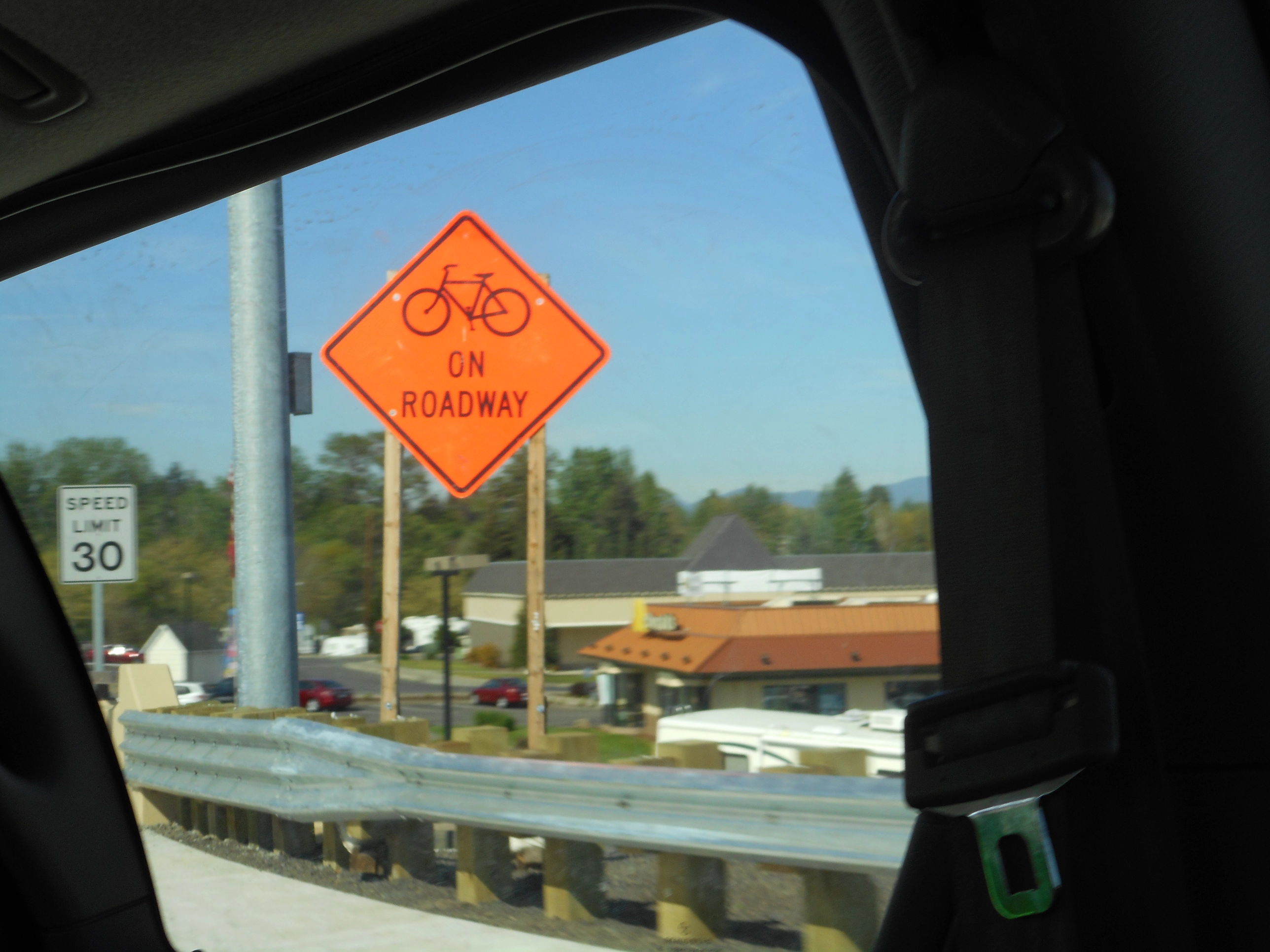 A photo of a bicycles on roadway sign